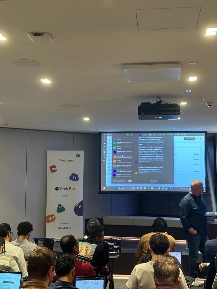 a room of builders watching a talk at an agent meetup in dubai