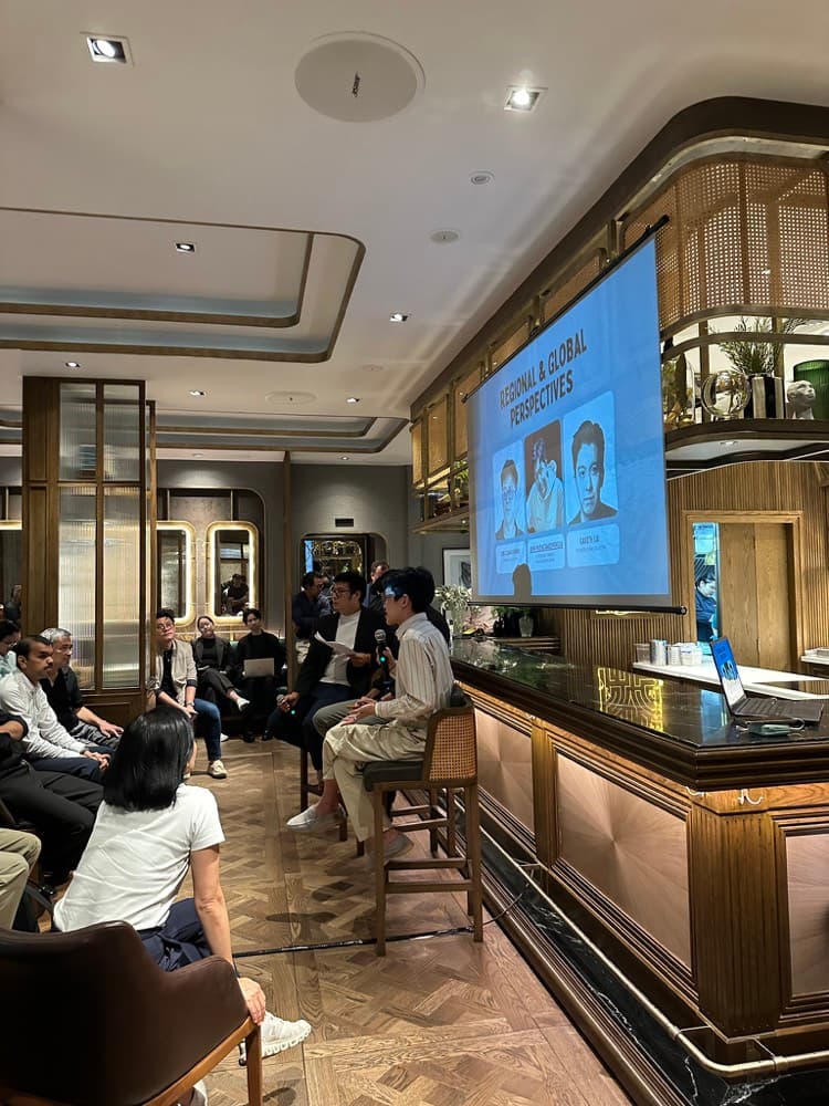 a panel on stage in bangkok under a screen about regional and global perspectives